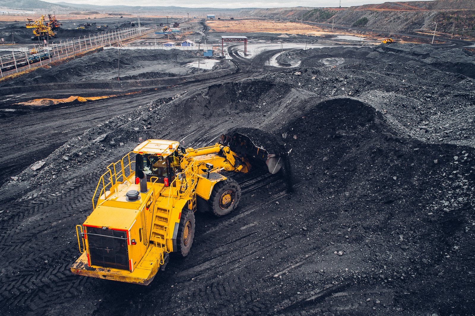 Aerial view of an open-pit coal mine with heavy machinery