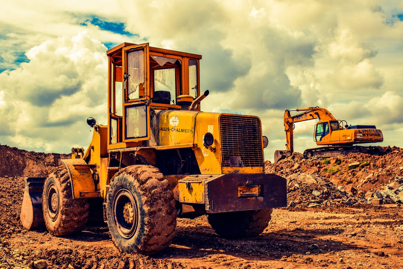 Front loader and excavator working on a plant hire site